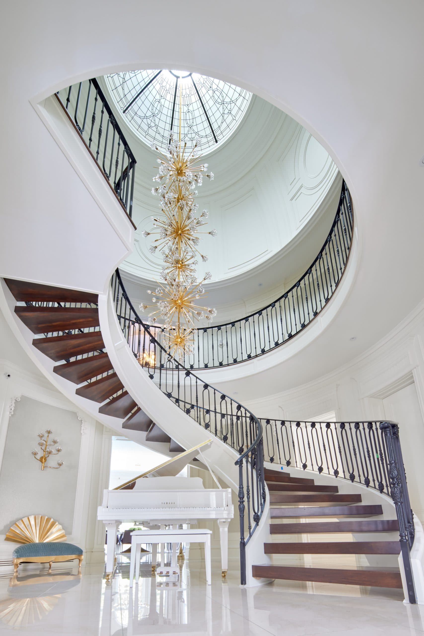 A curved staircase in a Pahlevan Homes custom residence